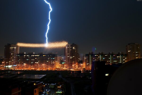 Omsk high-rise buildings and lightning in the night sky