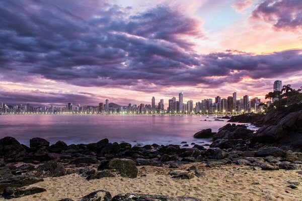 Lights of the night city at the wild beach