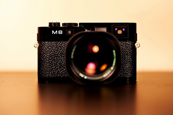 Black leica m8 camera with beautiful highlights in the lens