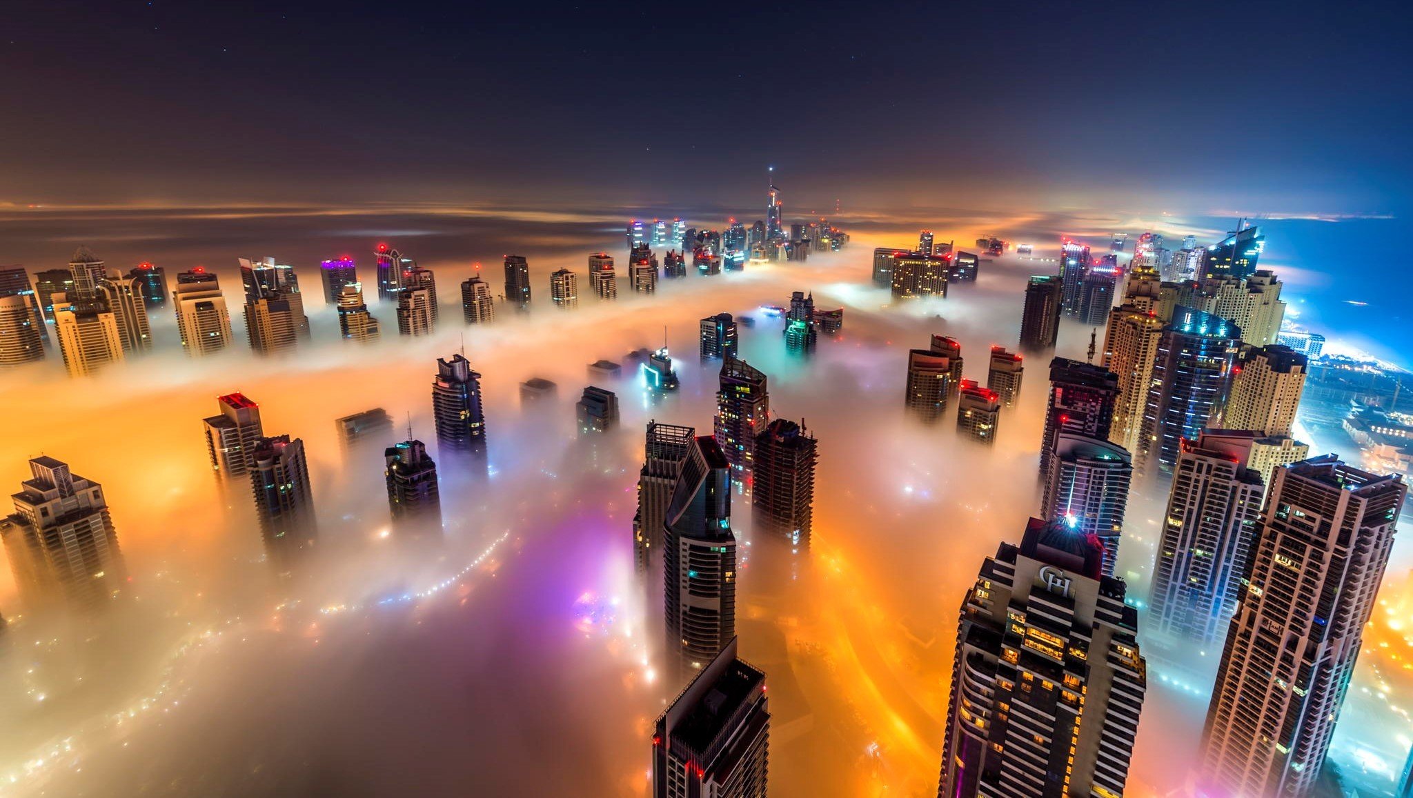 town high-rise buildings night fog light sea