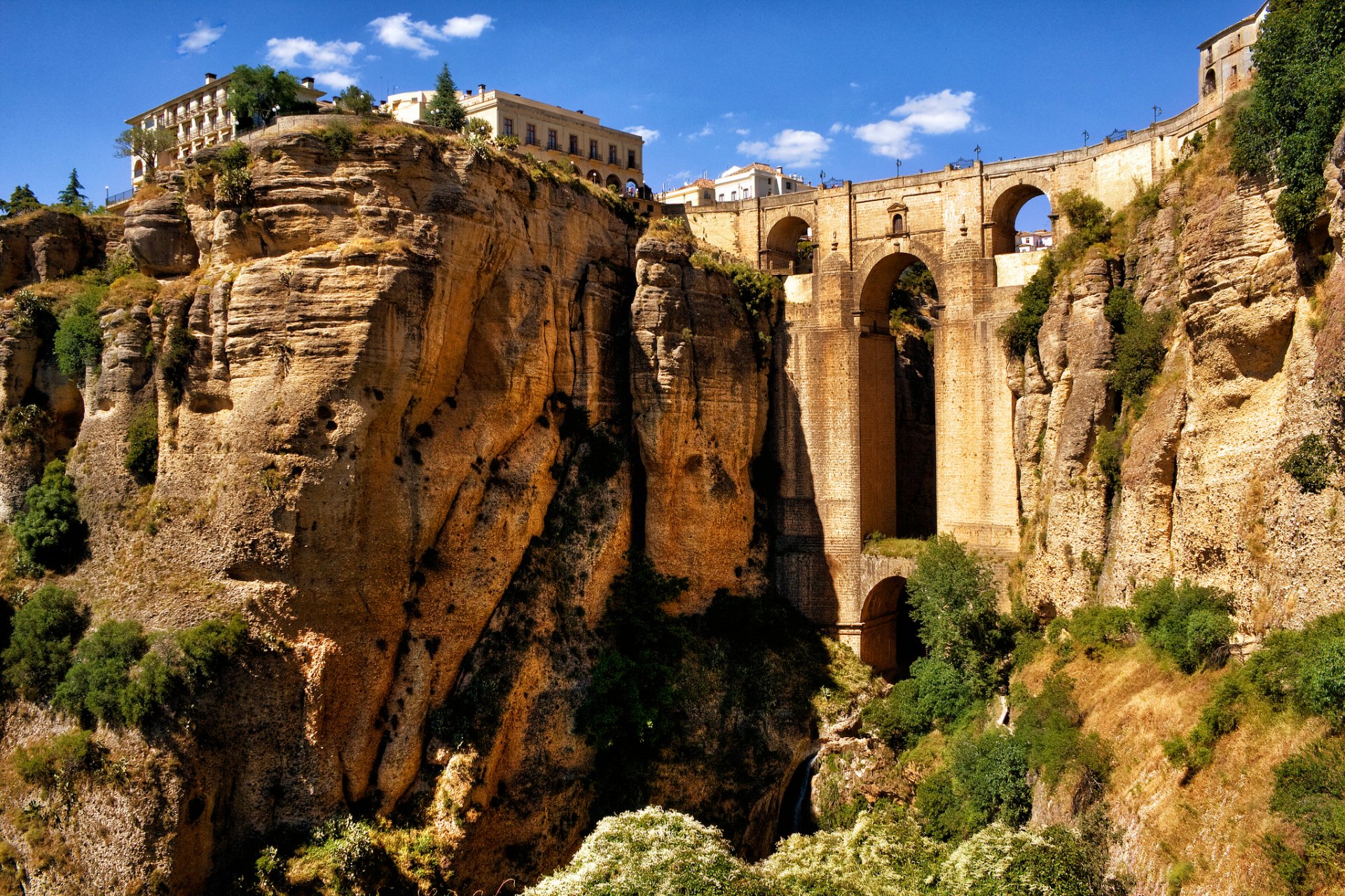 ronda andalusia spain sky mountain rock house aqueduct bridge arch valley