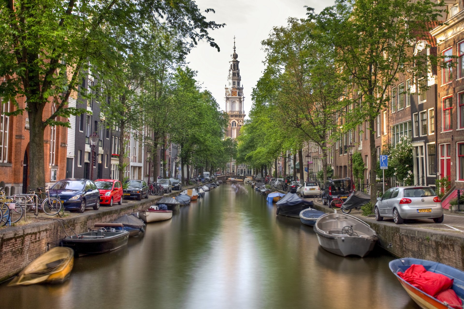 amsterdam netherlands city canal bridge boats river water houses buildings trees cars bicycle