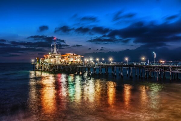 Photos of the evening city with pier, bridge, sea