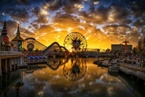 Ferris wheel at sunset by the river