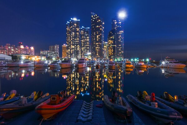 Molo notturno illuminato dalle luci dei grattacieli