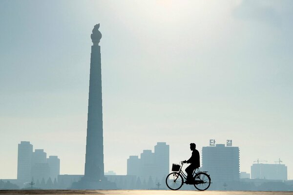 Uomo che passa in bicicletta città di Pyongyang