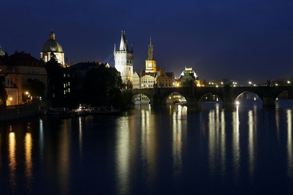 Reflection of lanterns in the river at night in Prague