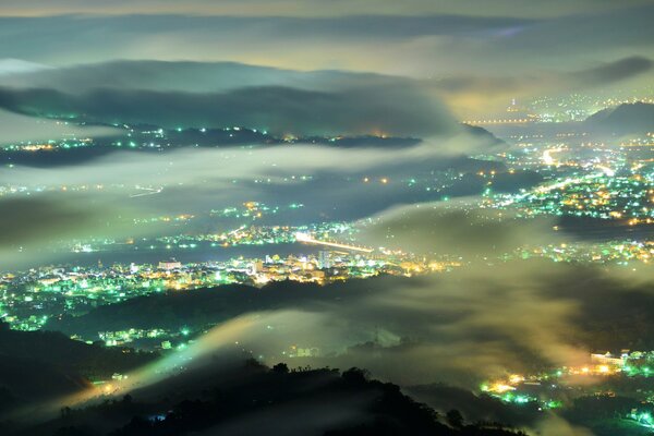 View of the city lights in the fog at night