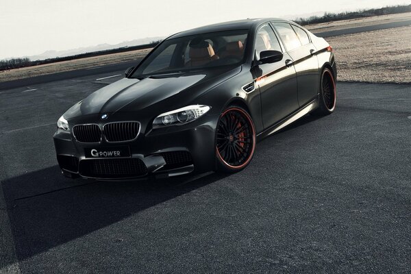 Black tuned BMW on the road