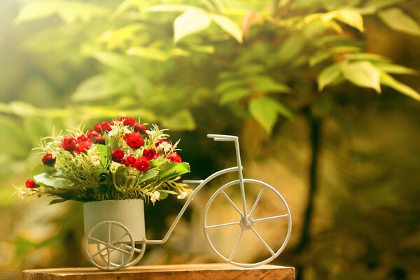 A bouquet of bright flowers in a bicycle-shaped basket