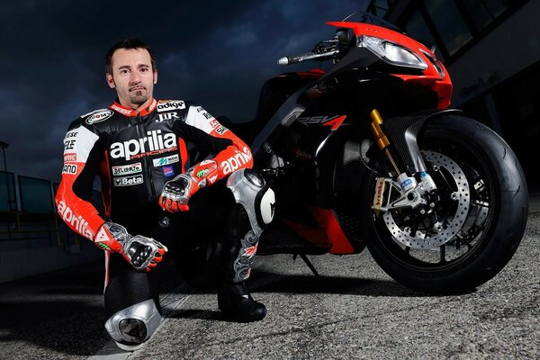 Motorcycle ZX - 10r with a motorcyclist posing on a dark background