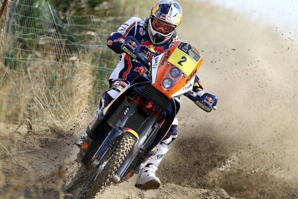 A dashing motorcycle racer in the wild, dirt is flying from under the wheels