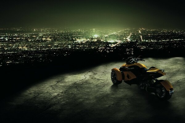 Yellow bike on the background of the lights of the mysterious city