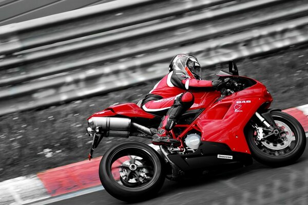 A blood-colored fast ducati flies to the dream on the skeleton of man