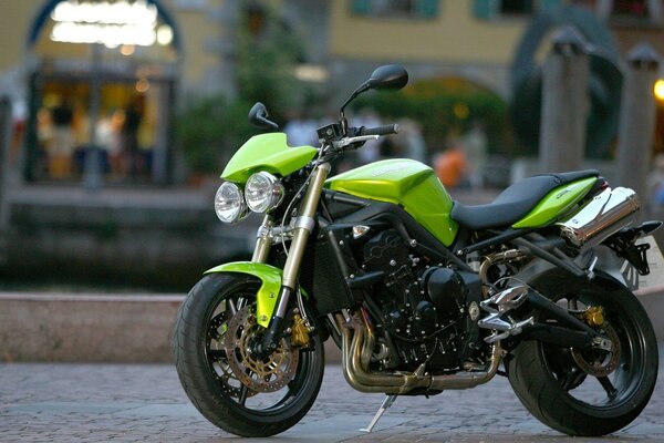 Green bike on the background of a busy street