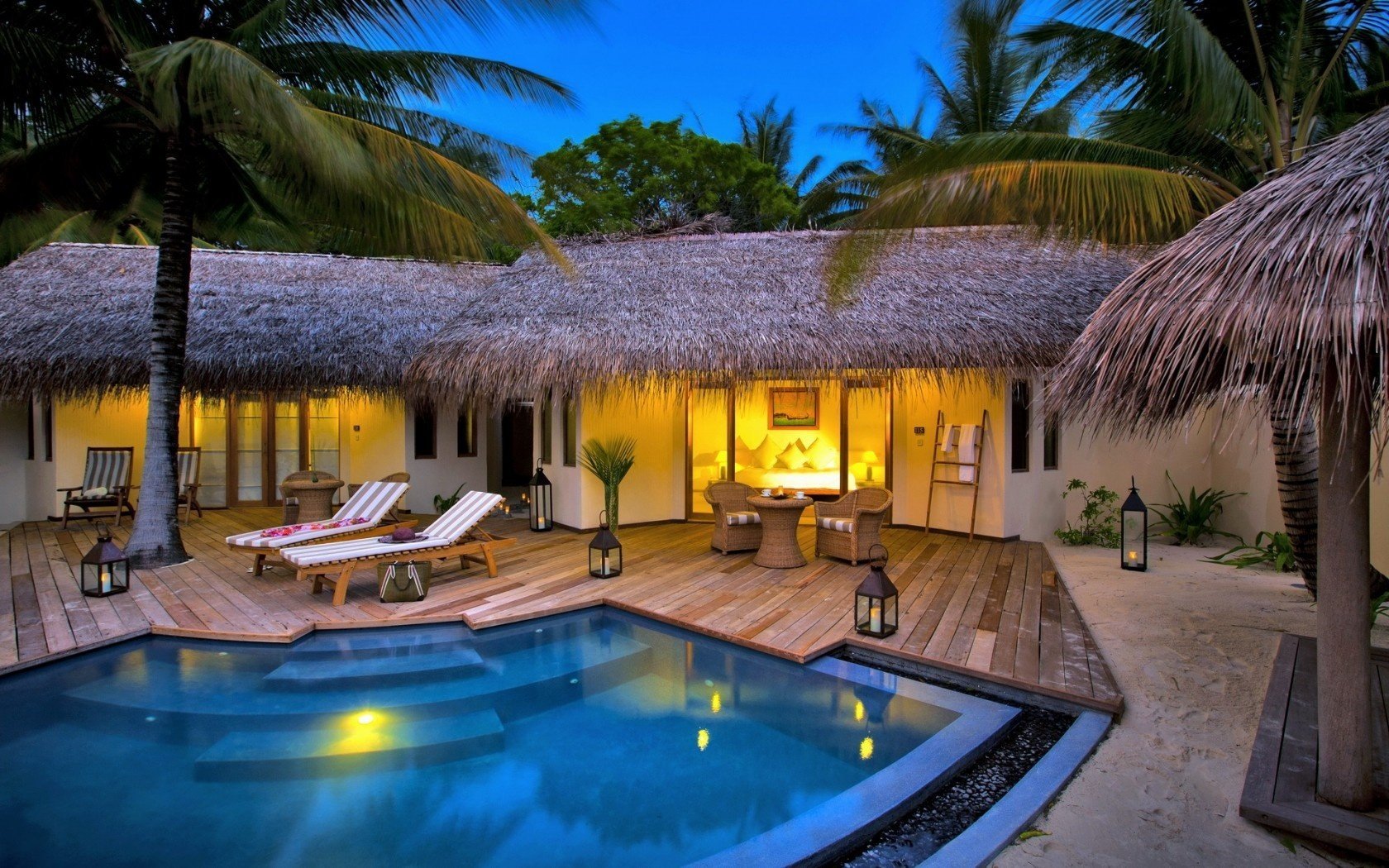 house sunbeds pool candles palm tree