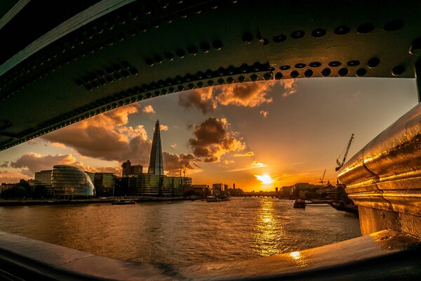 Sunset in London under the bridge on the river