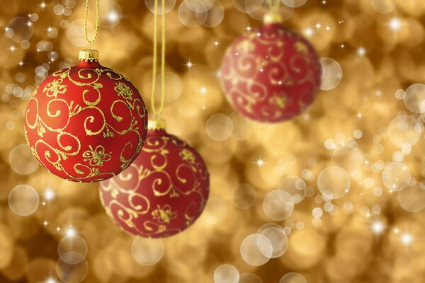 Red Christmas balls on a golden background