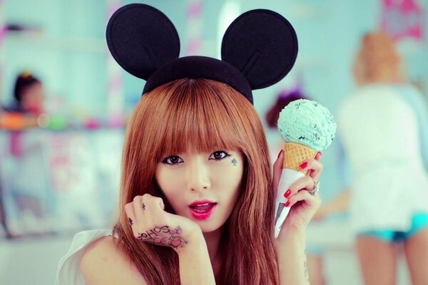 Asian girl with Mickey Mouse ears and ice cream