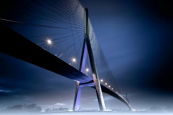 Night lights of the bridge in the fog