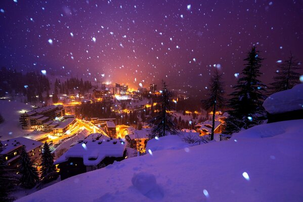 Beautiful view of the snow-covered village in bright lights