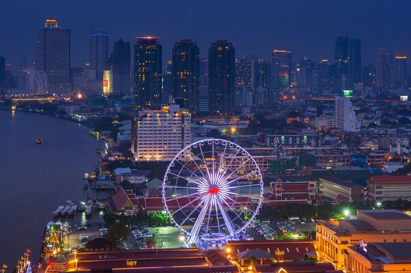 Ferris wheel on the background of Bangkok at night