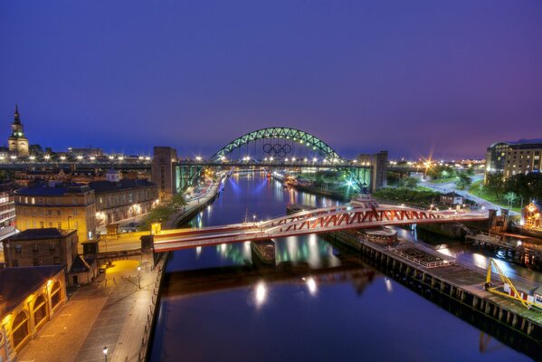 Bridge over the river in the lights of the evening city