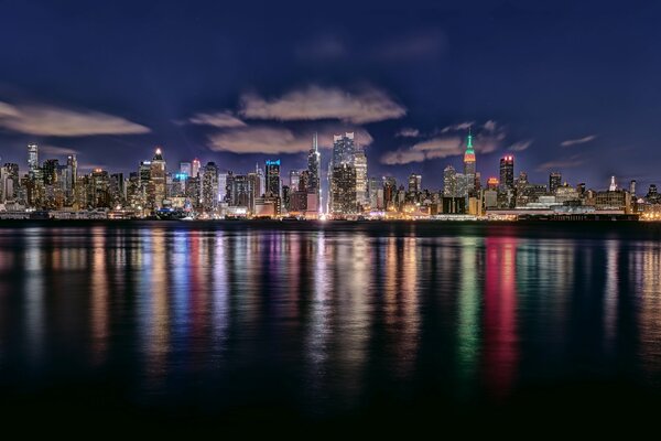 Night New York in the USA. Reflection of the city in the river