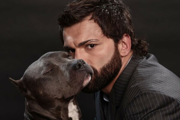 A man with a beard and a pit bull