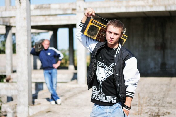 Two people with tape recorders on the background of a construction site