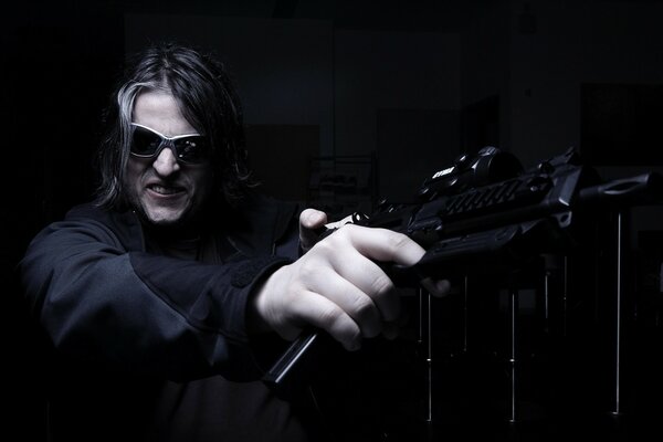 A man with a gun. A man with long hair