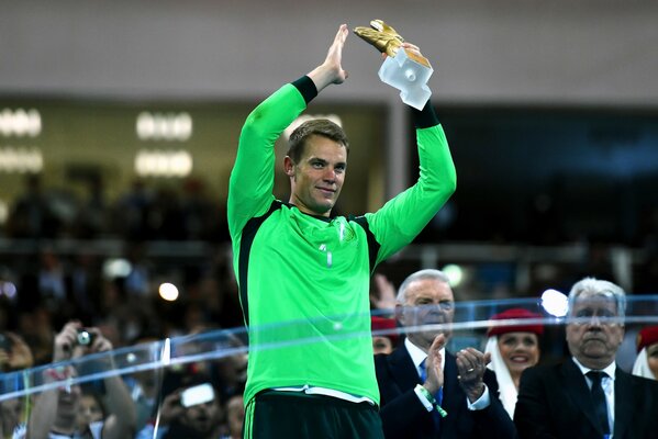 The goalkeeper raises the cup