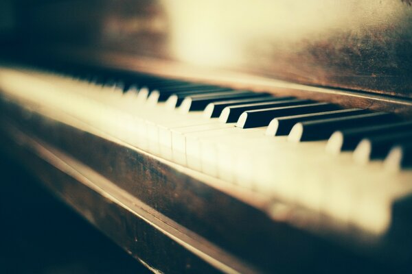 An old worn piano and black and white keys