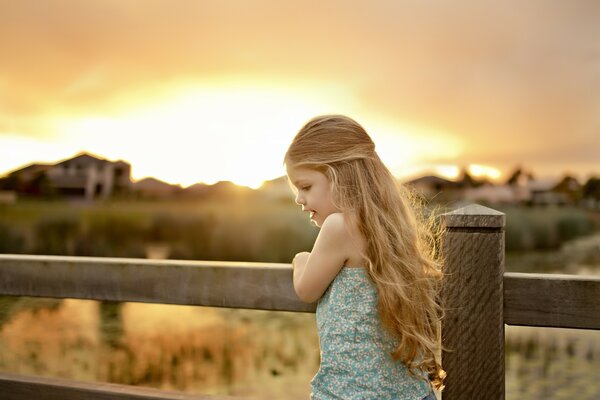 A girl with long hair near the fence