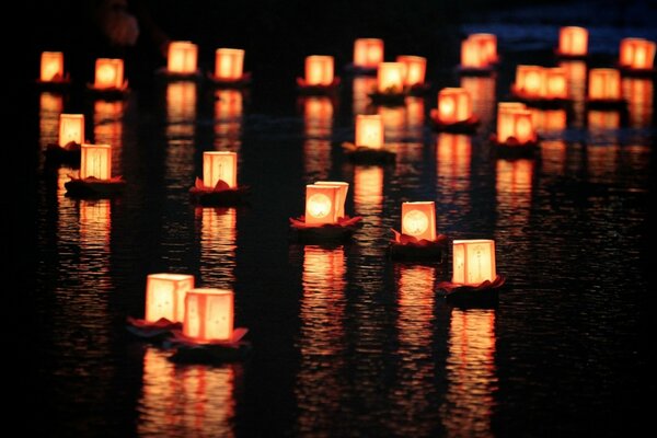 Lanterns in boats float on the river