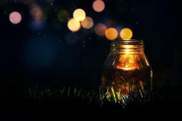 An unusual candle in a glass jar. Night photo