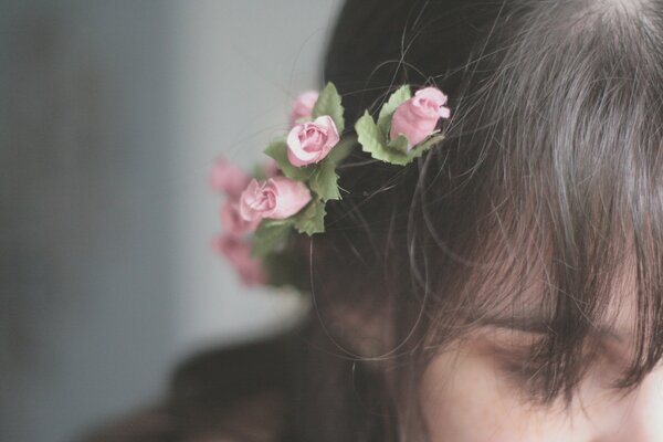 A girl with pink flowers in her hair