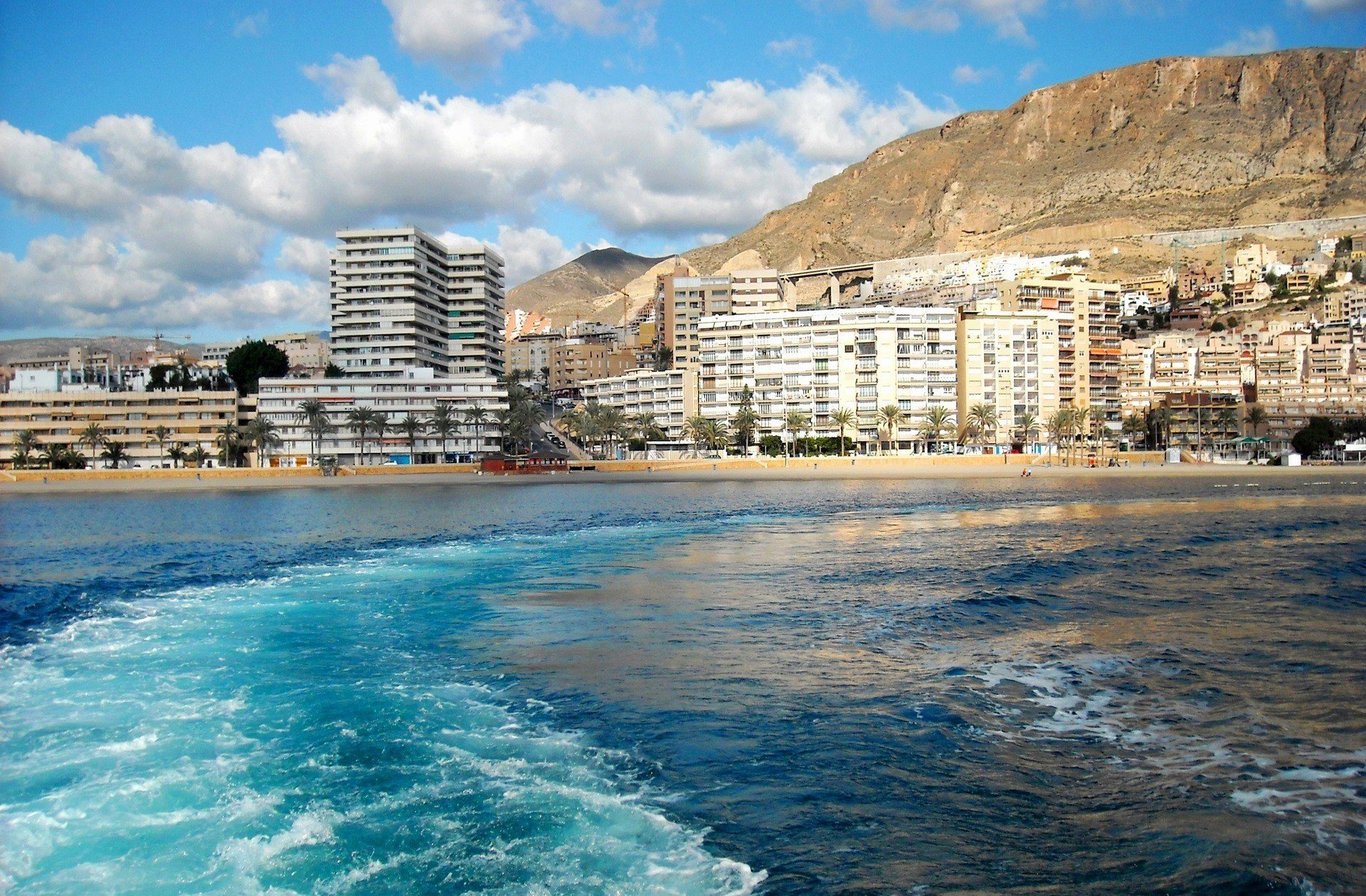 town country spain andalusia roquetas de mar mountain buildings water sea waves sky cloud