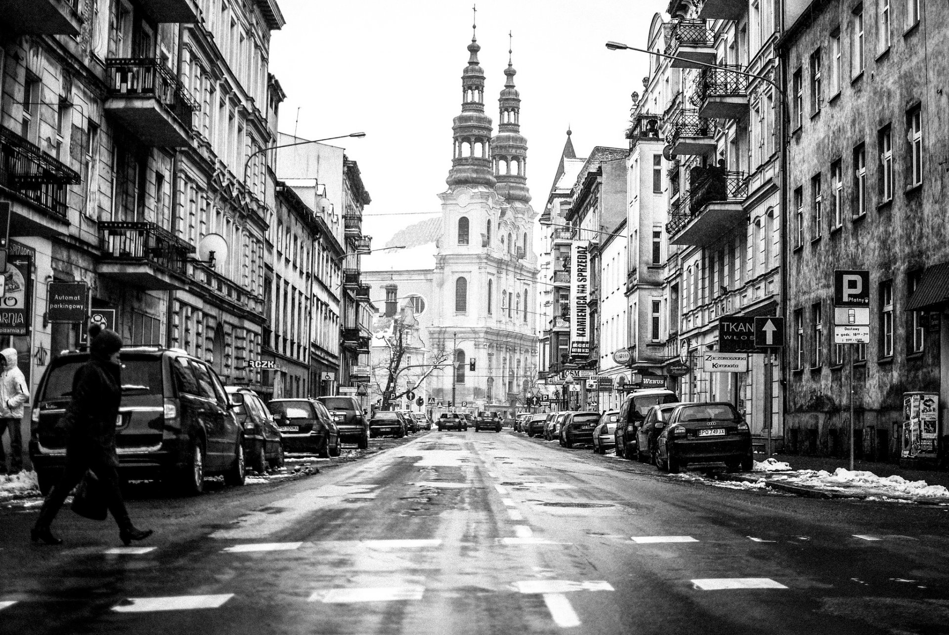 poznan poland town street road pavement machinery people pedestrian house shop