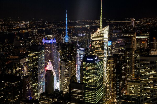 Photo of New York City at night. Large skyscrapers