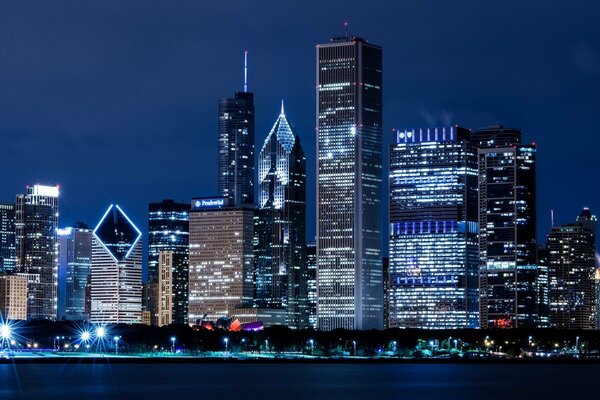 Skyscrapers along the river in the night city of Chicago