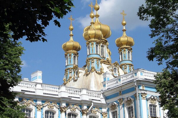 Golden domes of the temple against the blue sky