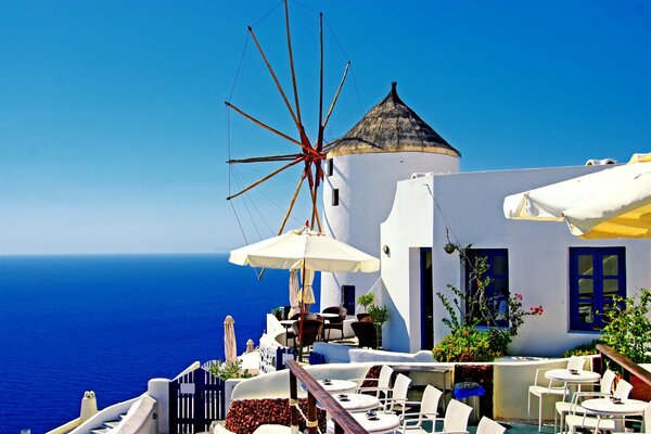 White mill on the background of the blue sea