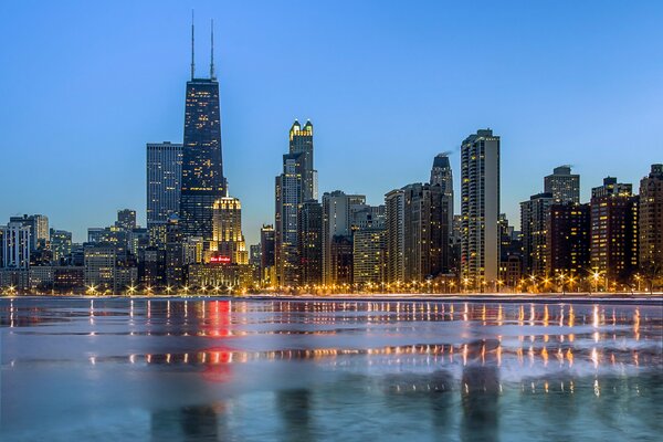 The lights of Chicago are reflected in the water