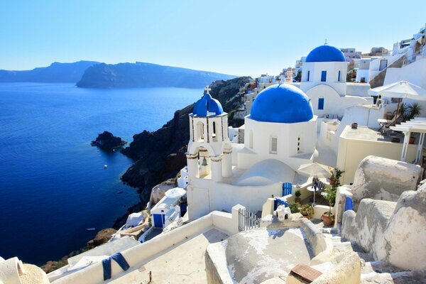 Santorini with white houses with blue roofs on the seashore