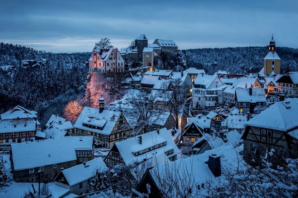 Houses covered with snow in evening Saxony