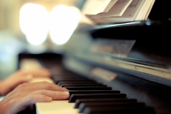 Background of hands on piano keys