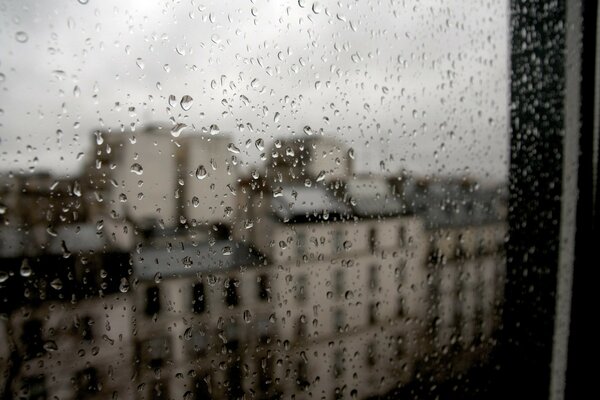 Paris outside the window covered with raindrops