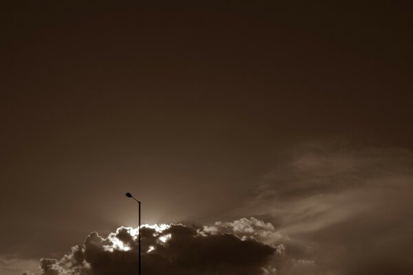 A lone lantern against a background of thick clouds closer to the horizon line