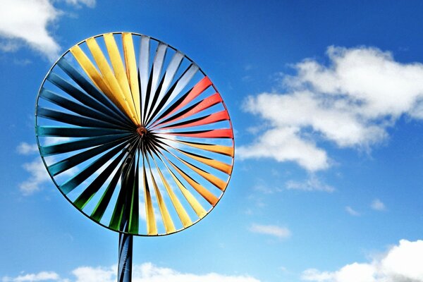 A windy colored turbine on a blue sky background